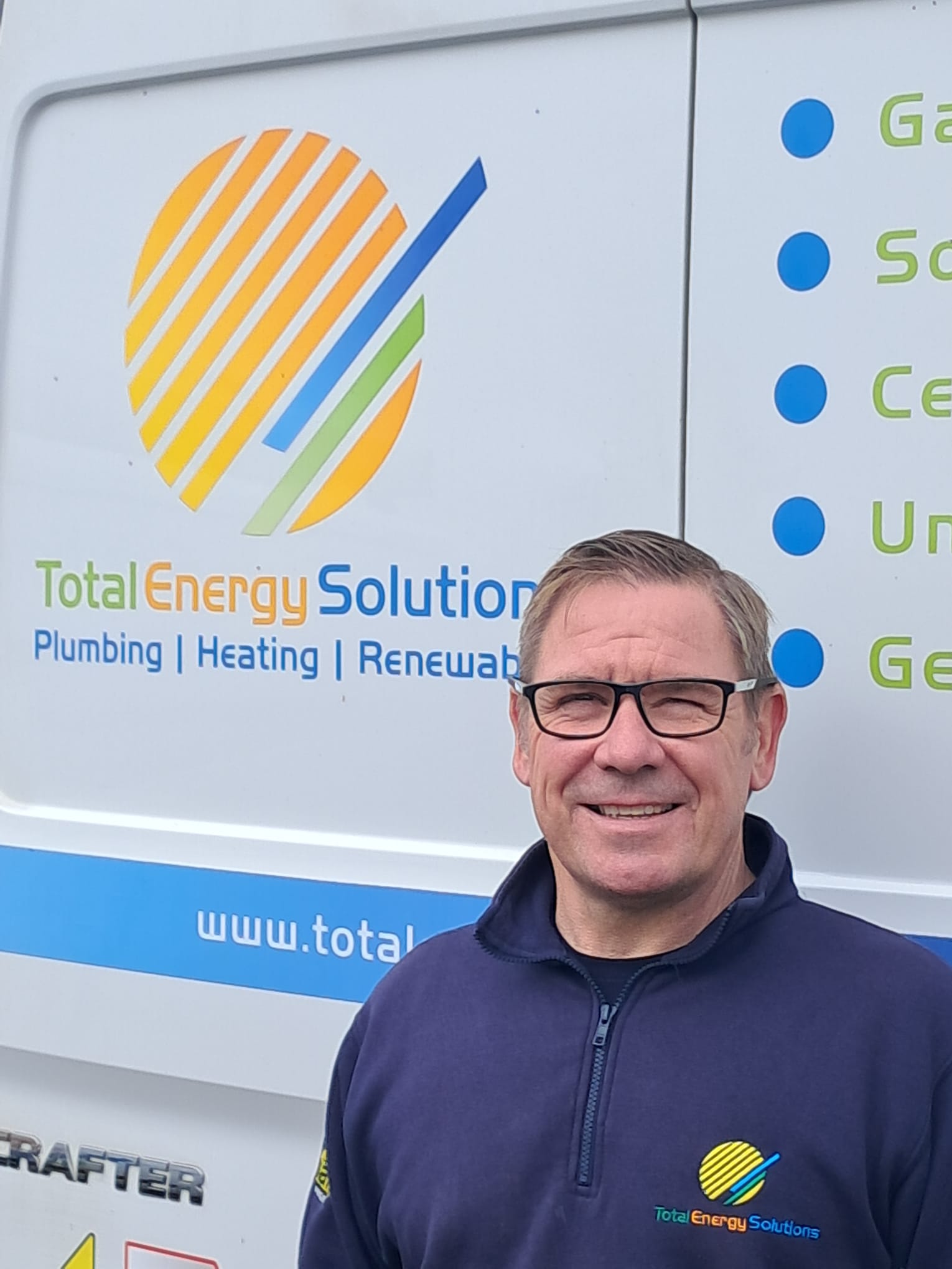 Stuart, founder of Total Energy Solutions, in front of a company van